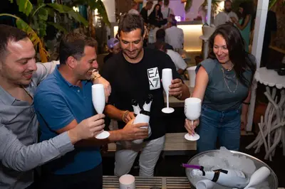 a group of people holding up white styrofoam cups at Hotel Parthenon Rodos city in Rhodes Town