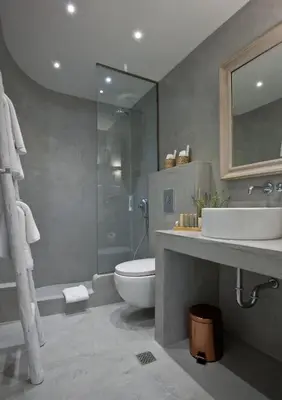 a bathroom with a toilet and a sink and a shower at Elements Villas in Lardos