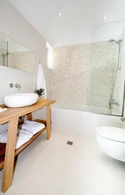 a bathroom with a sink and a tub and a toilet at Elements Villas in Lardos