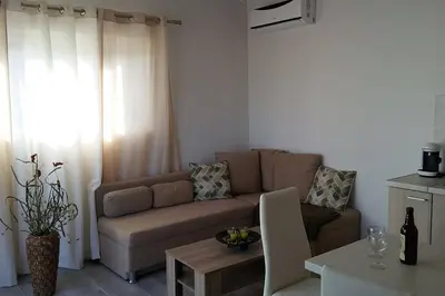 a living room with a couch and a table at Nianthy Apartments in Faliraki