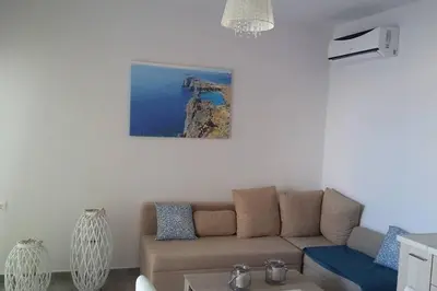 a living room with a couch and a table at Nianthy Apartments in Faliraki