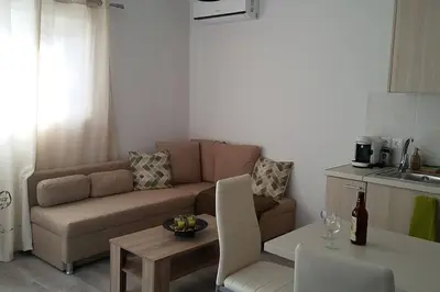 a living room with a couch and a table at Nianthy Apartments in Faliraki