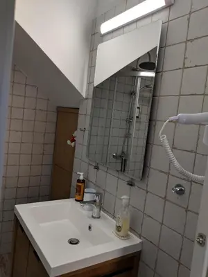 a bathroom with a sink and a mirror at Casita Del Sol Suites in Rhodes Town