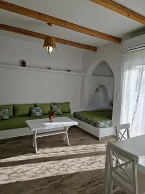 a living room with a couch and a bed at Seva's House in Psinthos