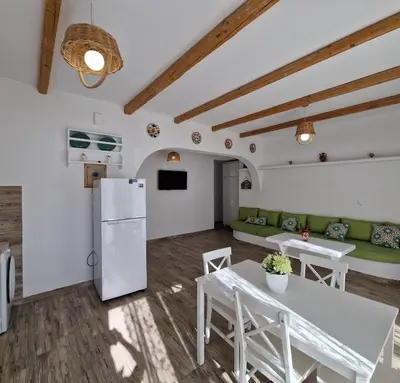 a kitchen and living room with a refrigerator and tables at Seva's House in Psinthos