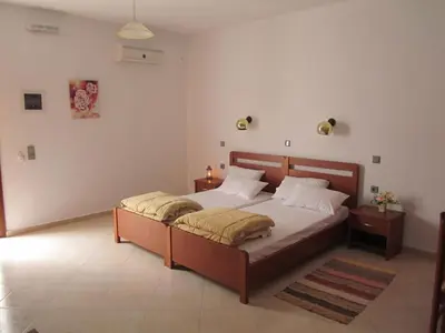 a bedroom with a large bed in a room at Tilos Fantasy in Livadia