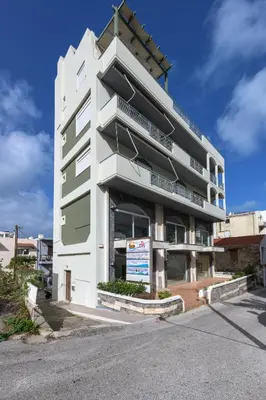 a white building with a sign in front of it at Sea and the city in Rhodes Town