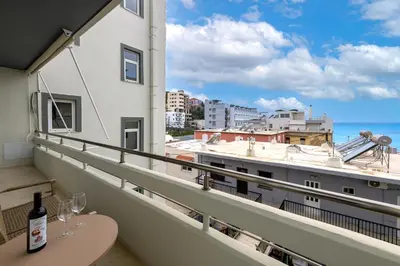 a balcony with a table and a view of the ocean at Sea and the city in Rhodes Town