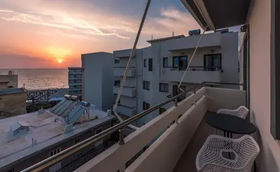 a balcony with a view of the ocean at sunset at Sea and the city in Rhodes Town