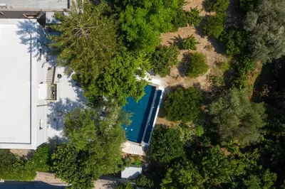 an overhead view of a swimming pool in a forest at Villa Eleonora in Rhodes Town