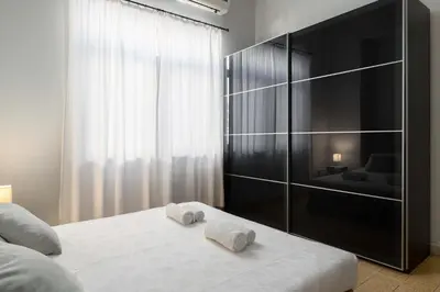 a bedroom with a bed with two towels on it at Villa Eleonora in Rhodes Town