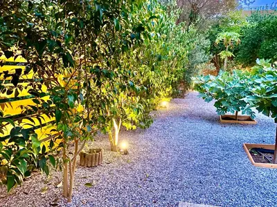 a garden with trees and lights on the ground at Villa Eleonora in Rhodes Town