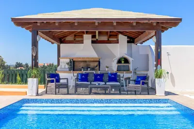 a pool with a gazebo and a swimming pool at Aegean Blue Villa in Koskinou