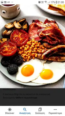 a plate of breakfast food with eggs and tomatoes at Maestro Apartments Faliraki in Faliraki