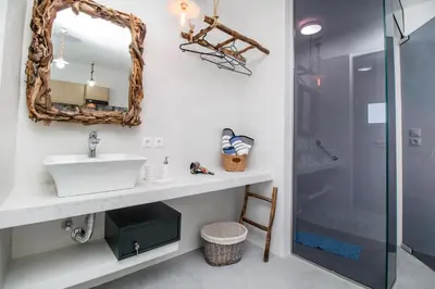 a bathroom with a sink and a shower at Len Art Alternative Studios in Faliraki