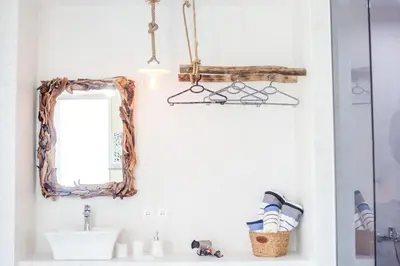 a bathroom with a mirror and a sink at Len Art Alternative Studios in Faliraki