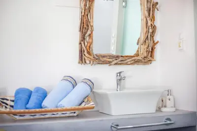 a bathroom with a sink and a mirror at Len Art Alternative Studios in Faliraki