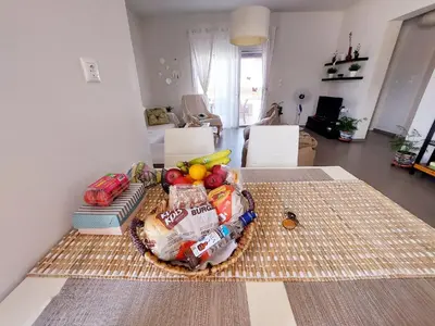 a basket of food on a table in a living room at Gennadi Serenity House- beachfront villa with pool in Gennadi