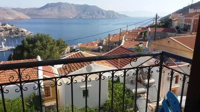 a view of the water from a balcony at Hotel Fiona Symi in Symi