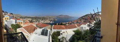 a view of a city with buildings and water at Hotel Fiona Symi in Symi
