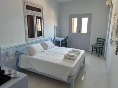 a bedroom with a bed with towels on it at Hotel Fiona Symi in Symi