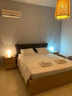 a bedroom with a bed with two towels on it at Villa Melita Seafront in Pefki Rhodes