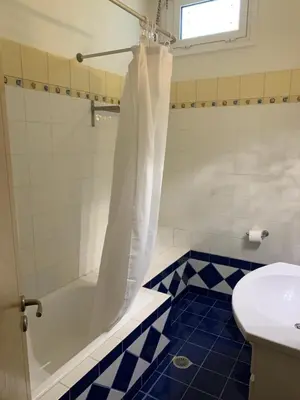 a bathroom with a tub and a toilet and a sink at Villa Melita Seafront in Pefki Rhodes