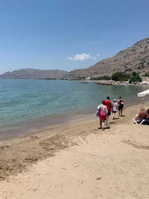 a group of people walking on the beach at Villa Melita Seafront in Pefki Rhodes