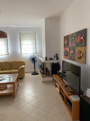 a living room with a couch and a flat screen tv at Villa Melita Seafront in Pefki Rhodes