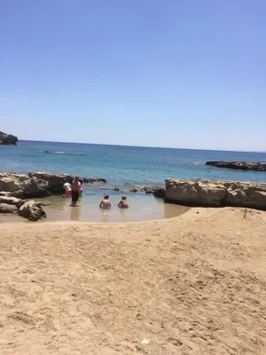 a group of people in the water on a beach at Villa Melita Seafront in Pefki Rhodes