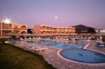 a large swimming pool with chairs and a hotel at Emerald Hotel in Kremasti