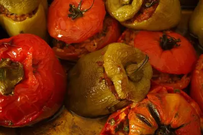 a pile of tomatoes and peppers on a table at GOJI Vegan Hotel in Ialyssos