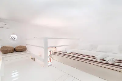 a white room with two beds and a table at Atlantis Houses in Halki