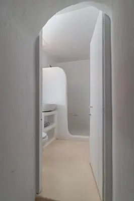 an open door to a bathroom with a toilet at Atlantis Houses in Halki