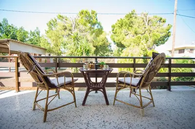 two chairs and a table on a patio at Country House in Pastida