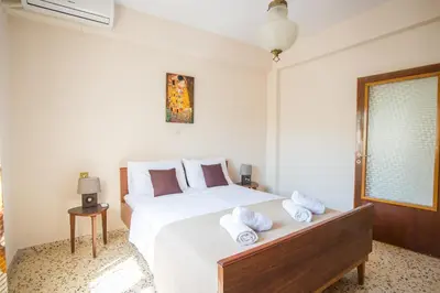 a bedroom with a large white bed with towels on it at Country House in Pastida