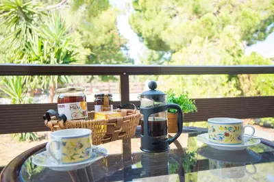 a glass table with two cups and a tea kettle at Country House in Pastida