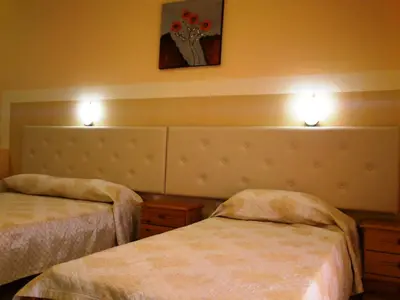 a hotel room with two beds and lights on the wall at Summer Memories Aparthotel in Pefki Rhodes