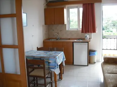 a kitchen with a table and a counter top at Summer Memories Aparthotel in Pefki Rhodes