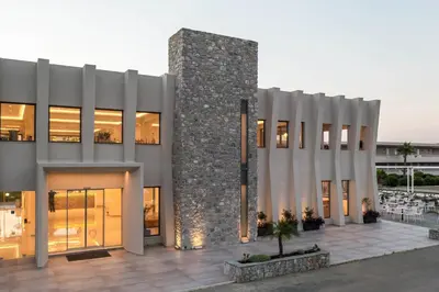 a facade of a building with a stone pillar at Lardos Bay Hotel in Lardos