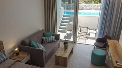 a living room with a couch and a table at Lardos Bay Hotel in Lardos