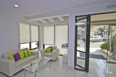 a living room with a couch and a table at Nafsika Hotel in Rhodes Town