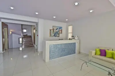 a living room with a fireplace and a couch at Nafsika Hotel in Rhodes Town