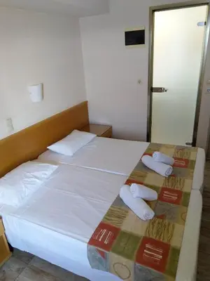 a hotel room with a bed with towels on it at Nafsika Hotel in Rhodes Town