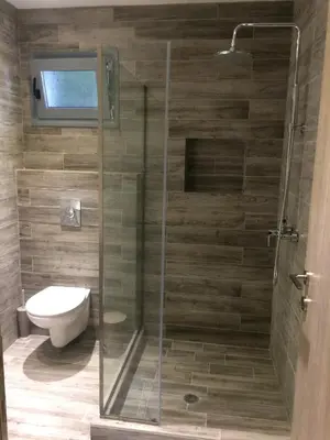 a bathroom with a glass shower with a toilet at Melita Apartment Seaside in Haraki
