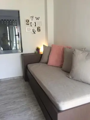 a couch in the corner of a room at Melita Apartment Seaside in Haraki