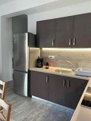 a kitchen with a stainless steel refrigerator and a sink at Melita Apartment Seaside in Haraki