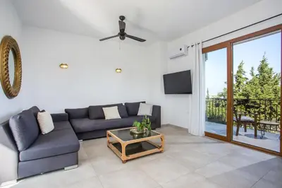 a living room with a couch and a table at Villa Kora in Kallithea Rhodes