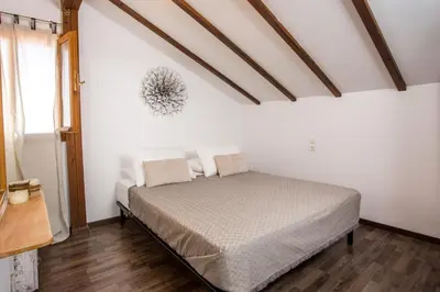 a bedroom with a bed in a white room at Villa Kora in Kallithea Rhodes