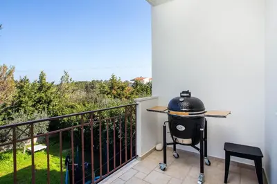 a grill on a balcony with a view at Villa Kora in Kallithea Rhodes